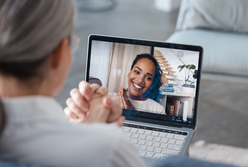 A woman is on her laptop and clapping